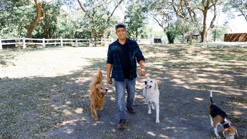 Coach Francis leading dogs at The Dog Ranch